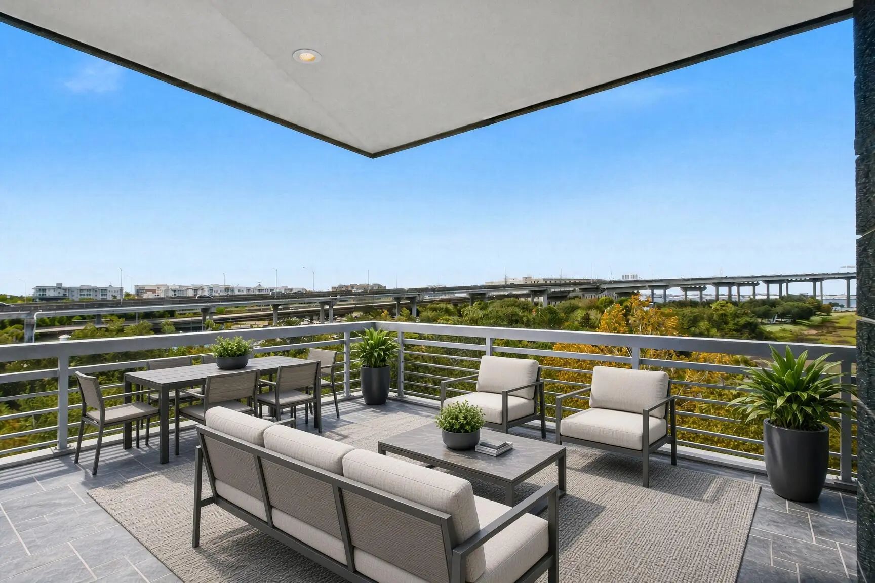 Covered terrace with outdoor seating overlooking the marsh and Wando River from unit 241 at The Tides, Mount Pleasant