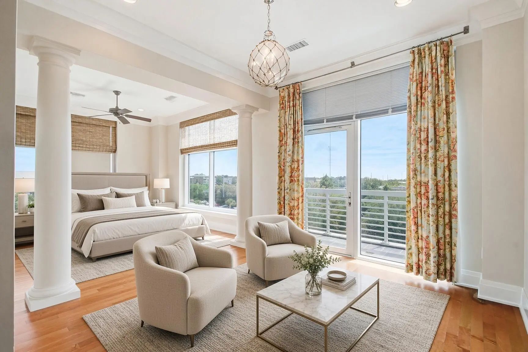 Primary bedroom with sitting area, columns and windows to the terrace and marsh at The Tides in Mount Pleasant, SC