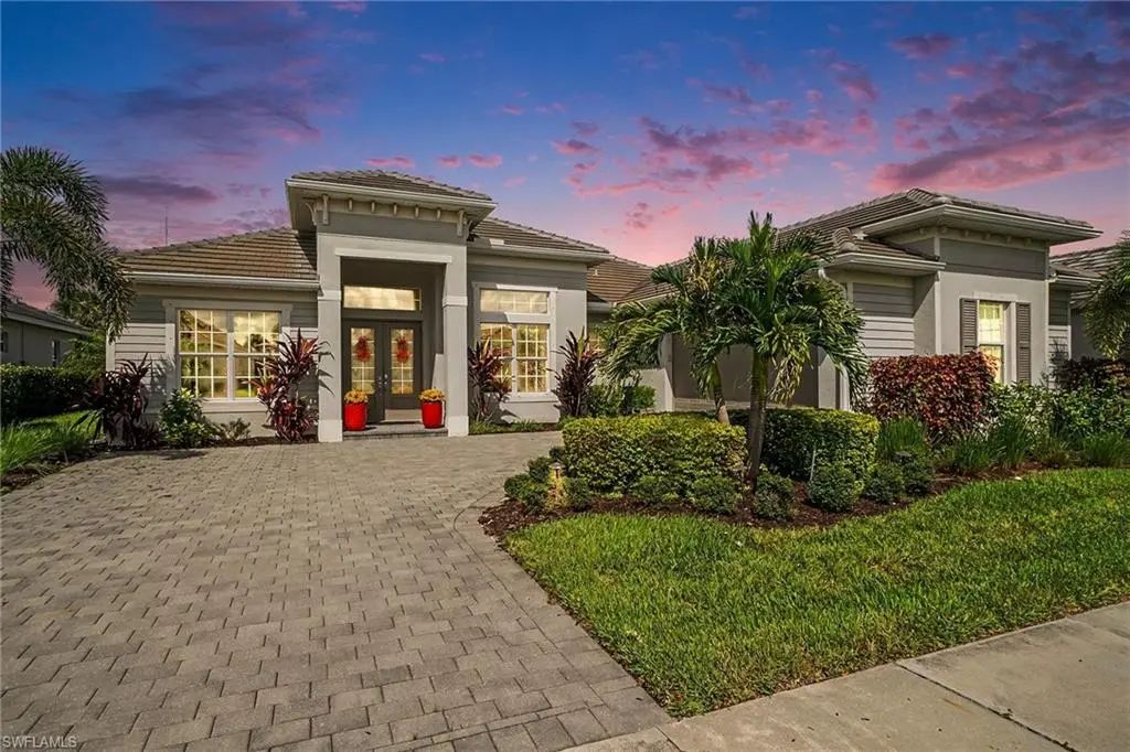 Twilight exterior of 15880 Talon Terrace, a single-story Westwind model with paver driveway in Babcock National, Punta Gorda, FL