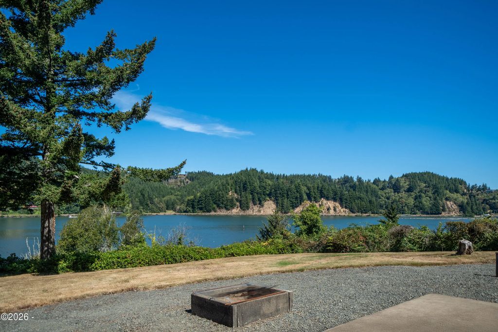 Rear patio and Yaquina River frontage at 6039 S Bay Road, Toledo, Oregon