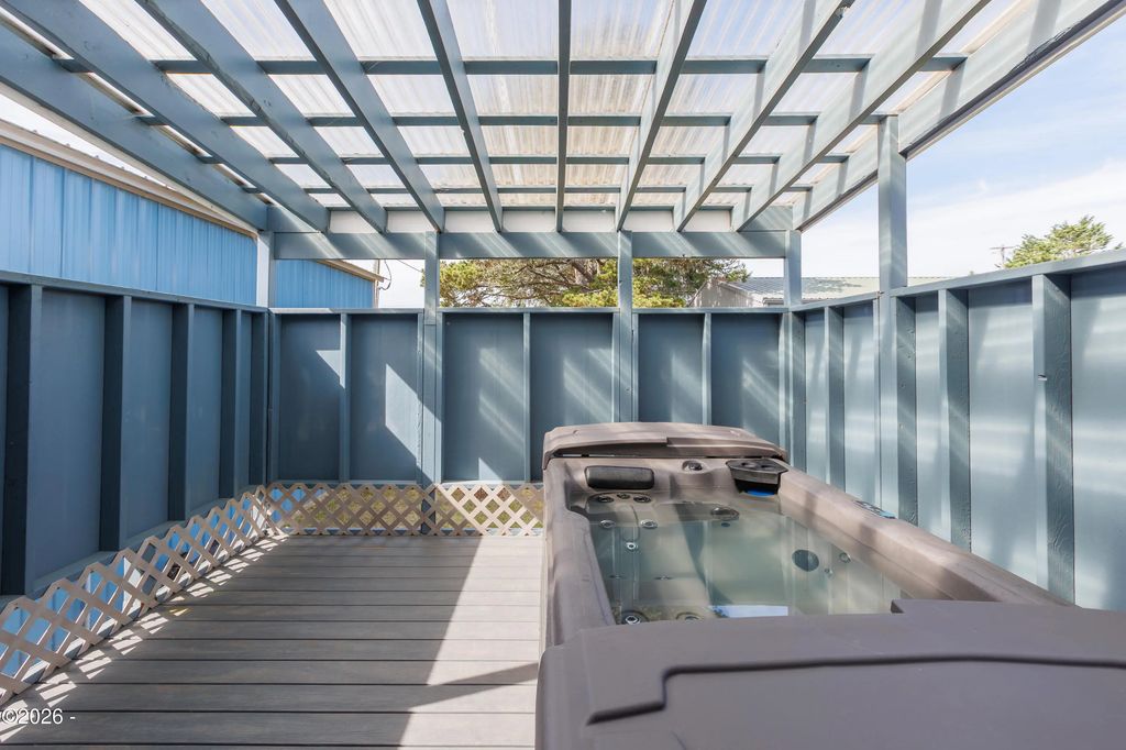 Fenced backyard and hot tub at 440 N Bay Street, Waldport, Oregon