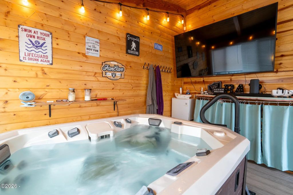 Covered sunroom with Marquis hot tub at 111 NW 58th Street, Newport, Oregon